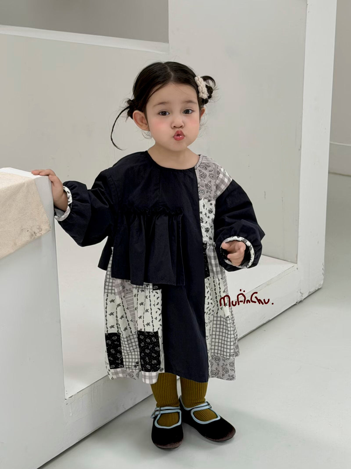 Original styling photo of the complete navy patchwork ruffle dress; tights, shoes and hair accessories are styling items.