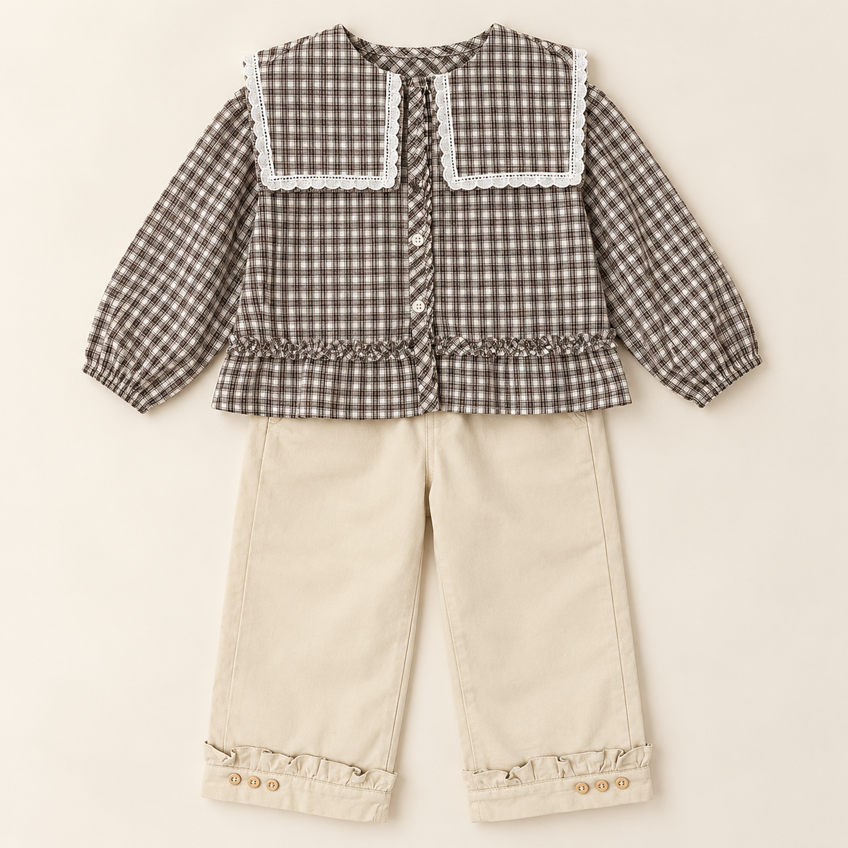 Two-piece outfit with lace collar plaid blouse and cream trousers.