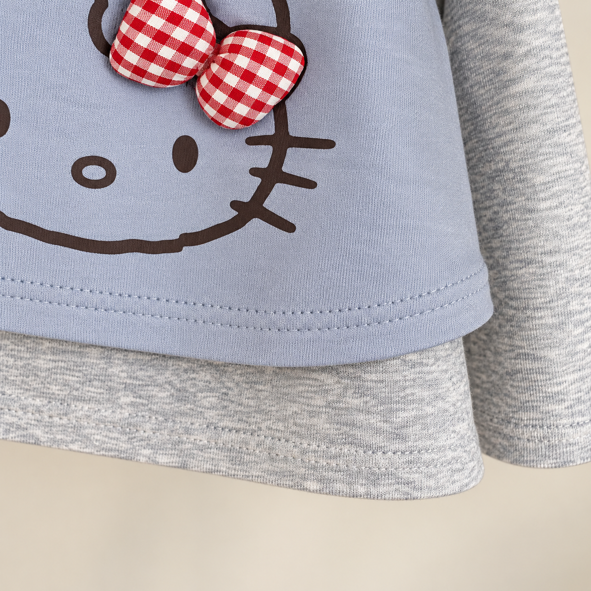 Blue cat bow top hem detail.