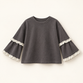 Charcoal-grey children's top with ivory lace-trimmed layered sleeves.