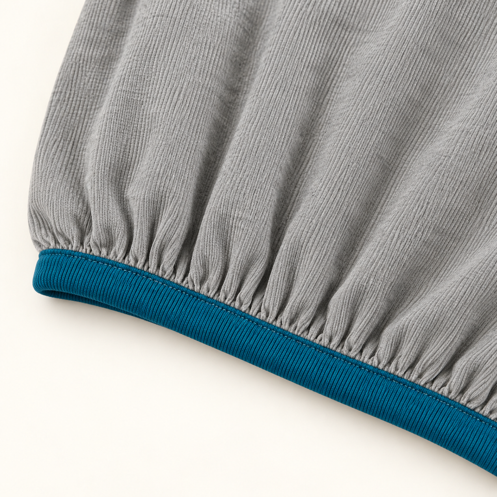 Grey contrast trim top teal hem and fabric detail.