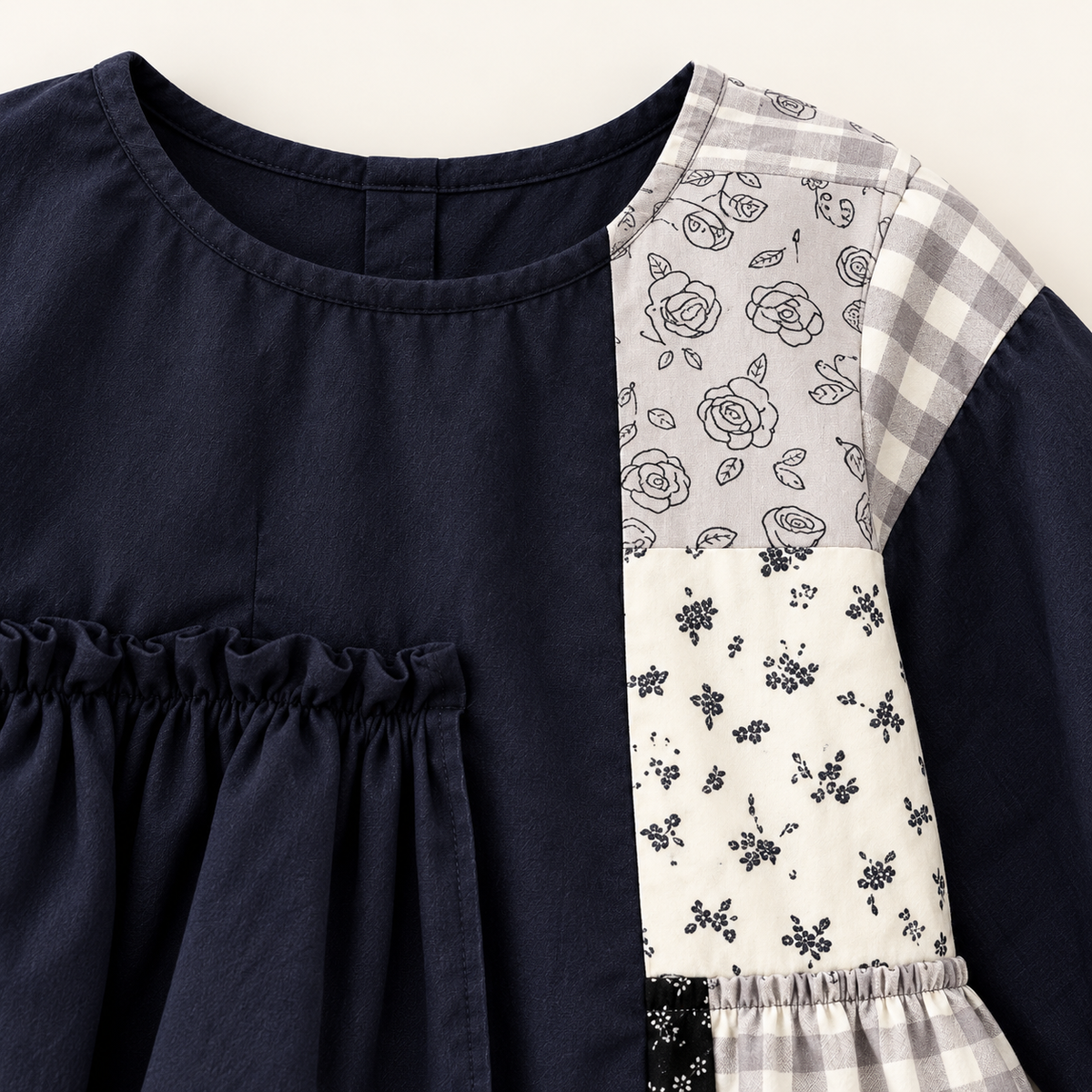 Navy patchwork ruffle dress, neckline detail.