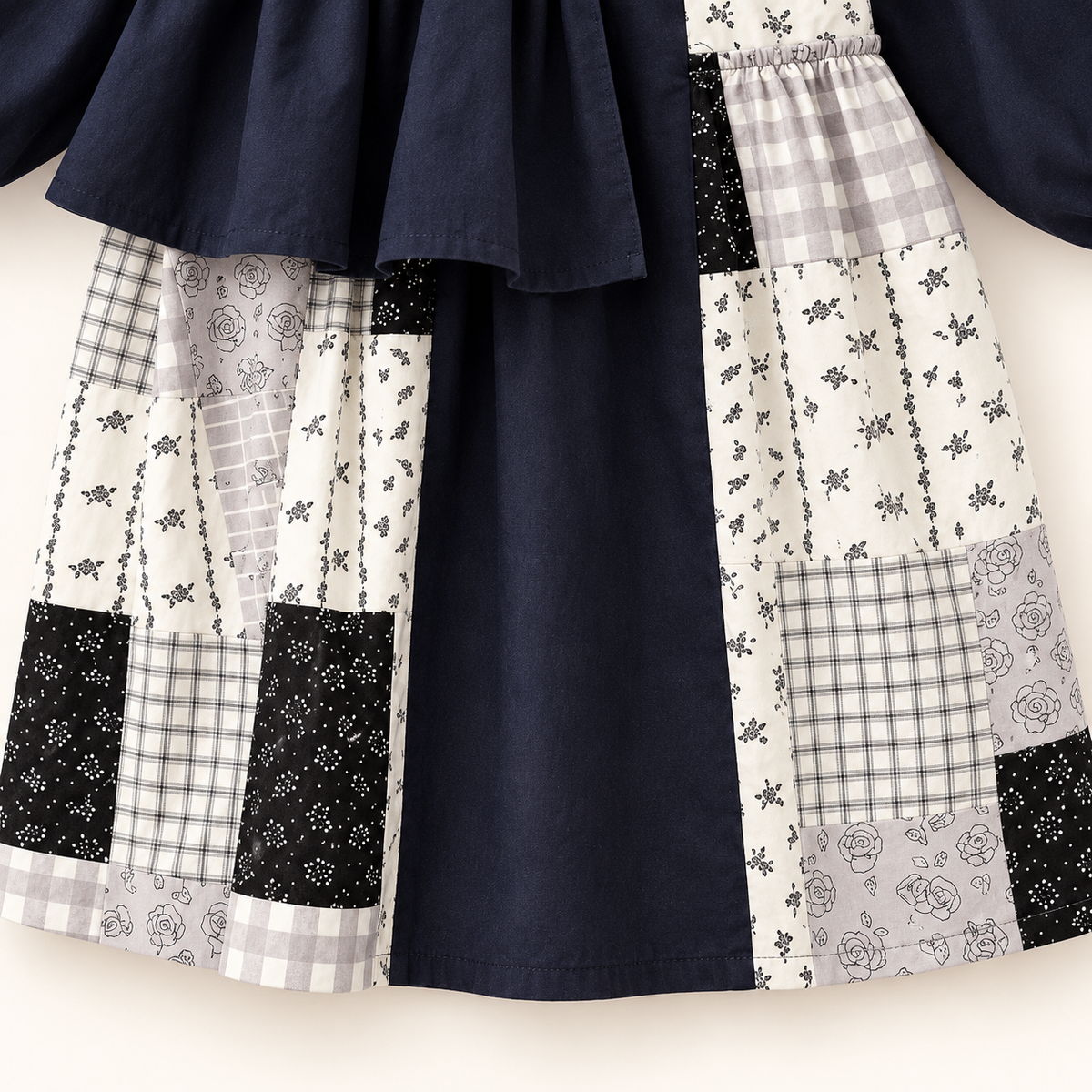 Navy patchwork ruffle dress, skirt and hem detail.