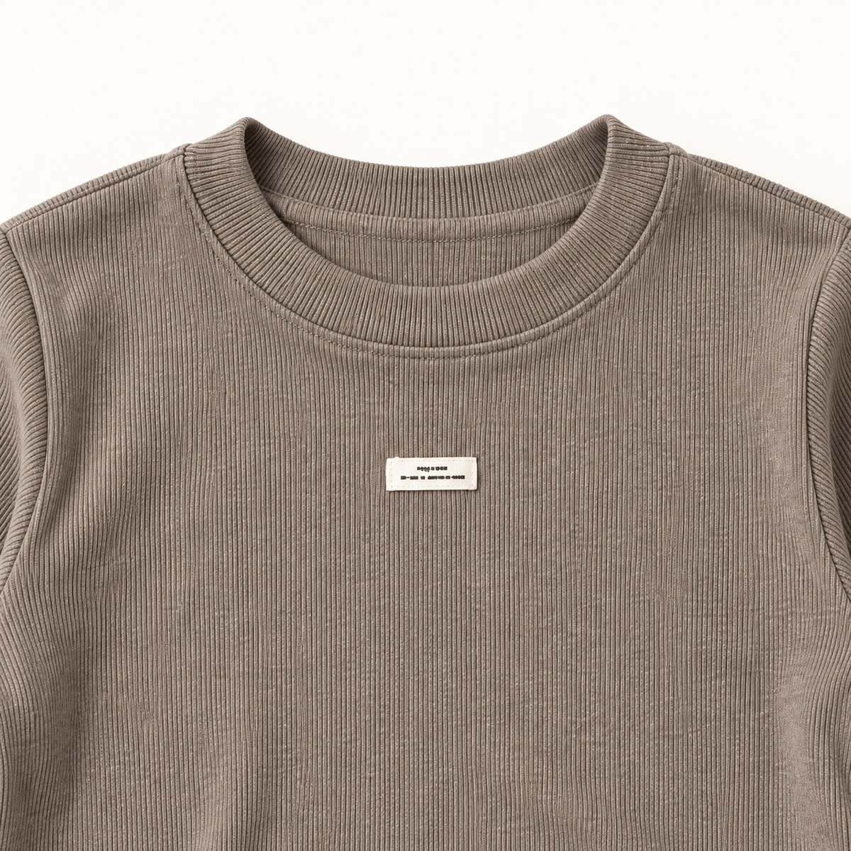 Taupe inner top crew neckline and chest label detail.