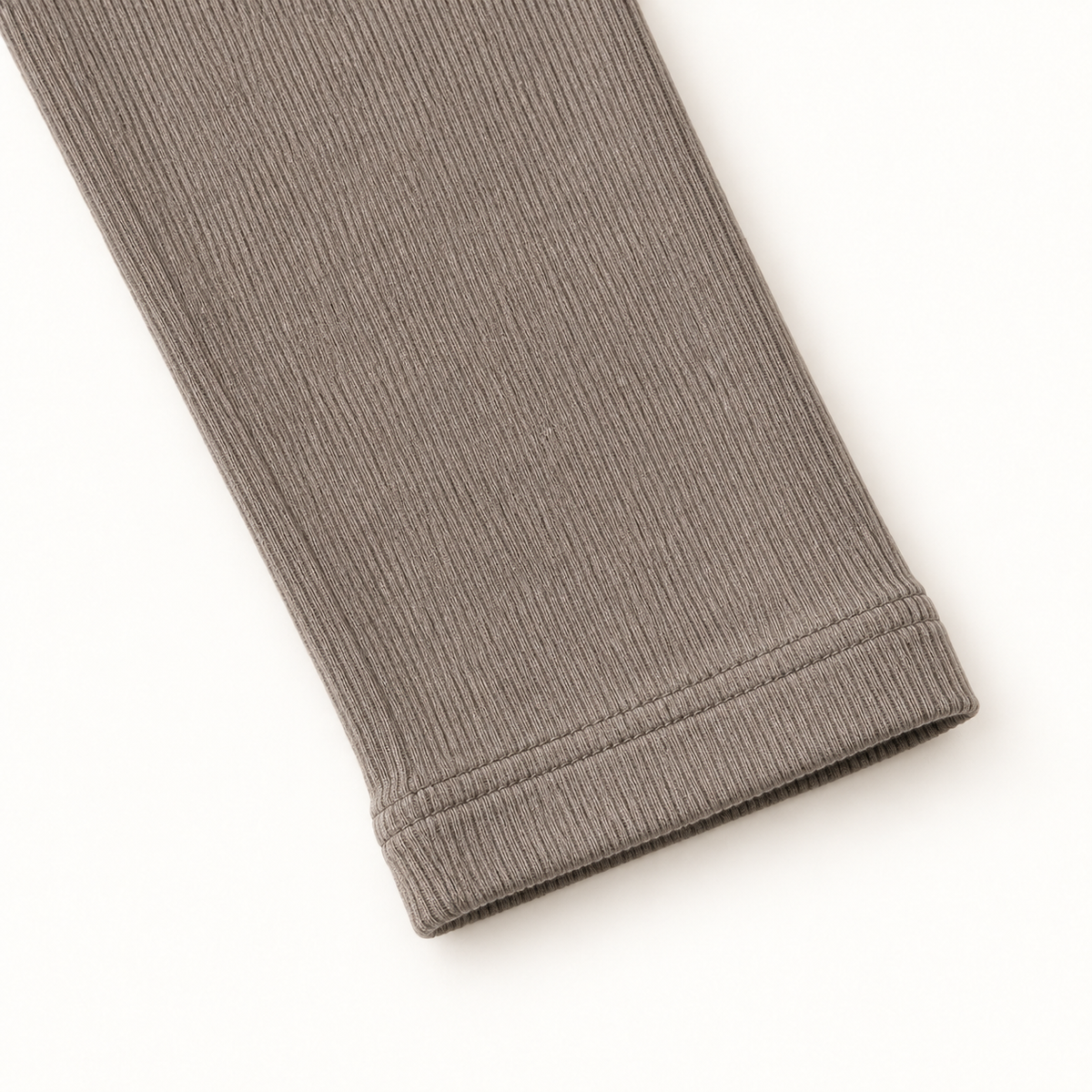 Taupe inner top sleeve cuff stitching and ribbed fabric detail.