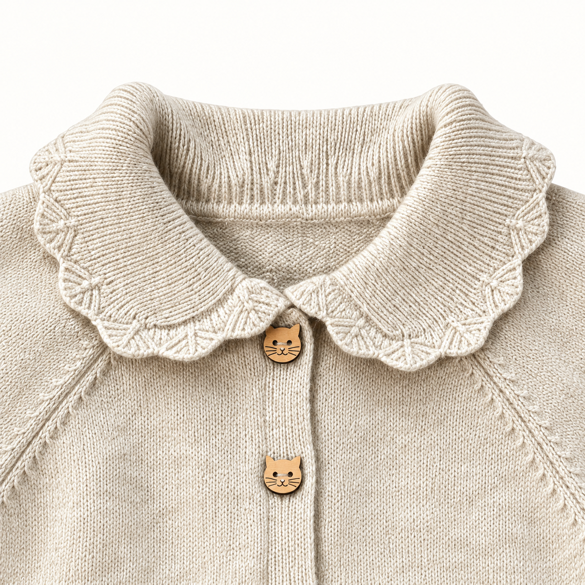 Ivory cardigan scalloped collar and cat-face buttons detail.