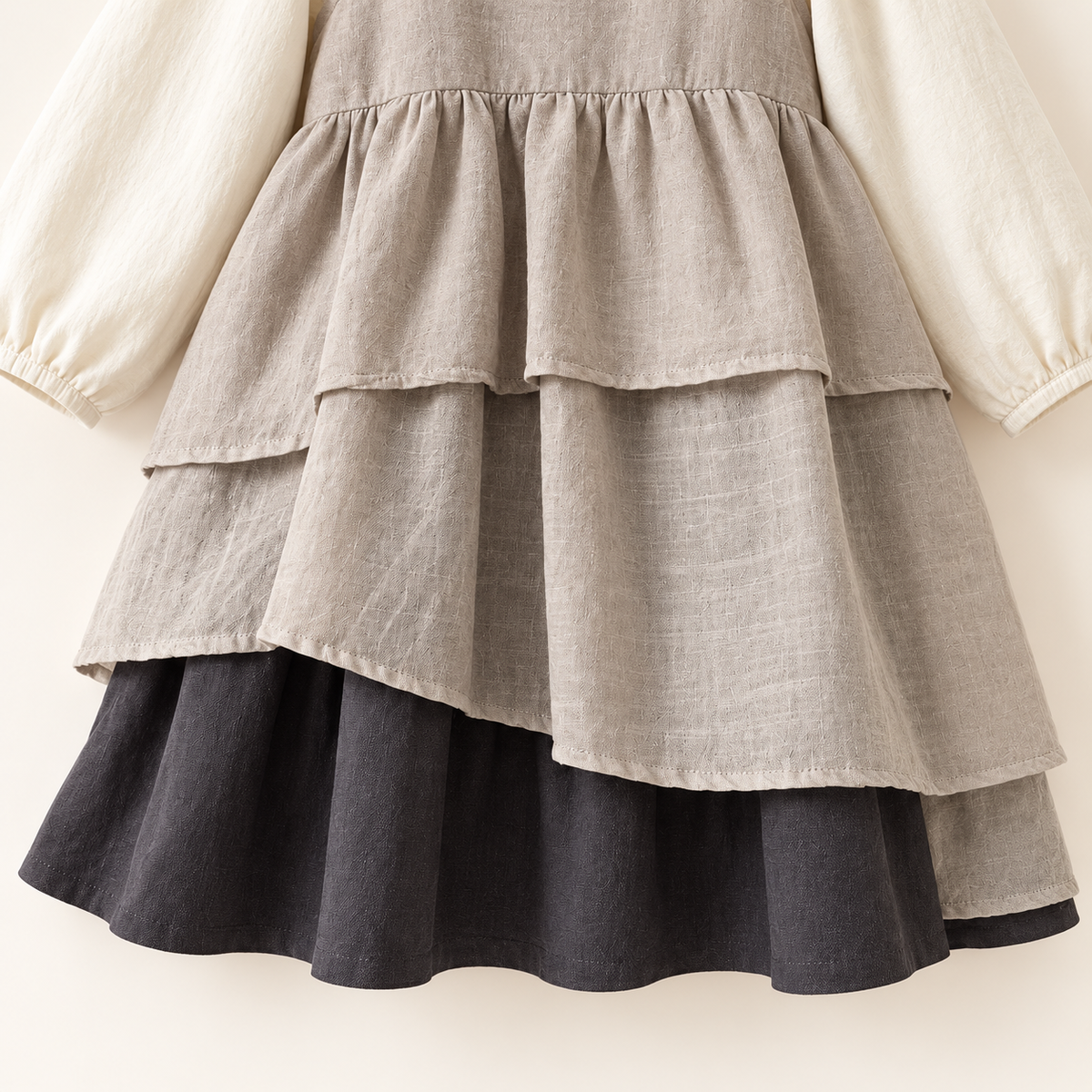 Taupe layered dress and ivory top set, skirt and hem detail.